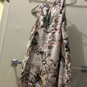 Floral and bird print sleeveless dress with high tie back.